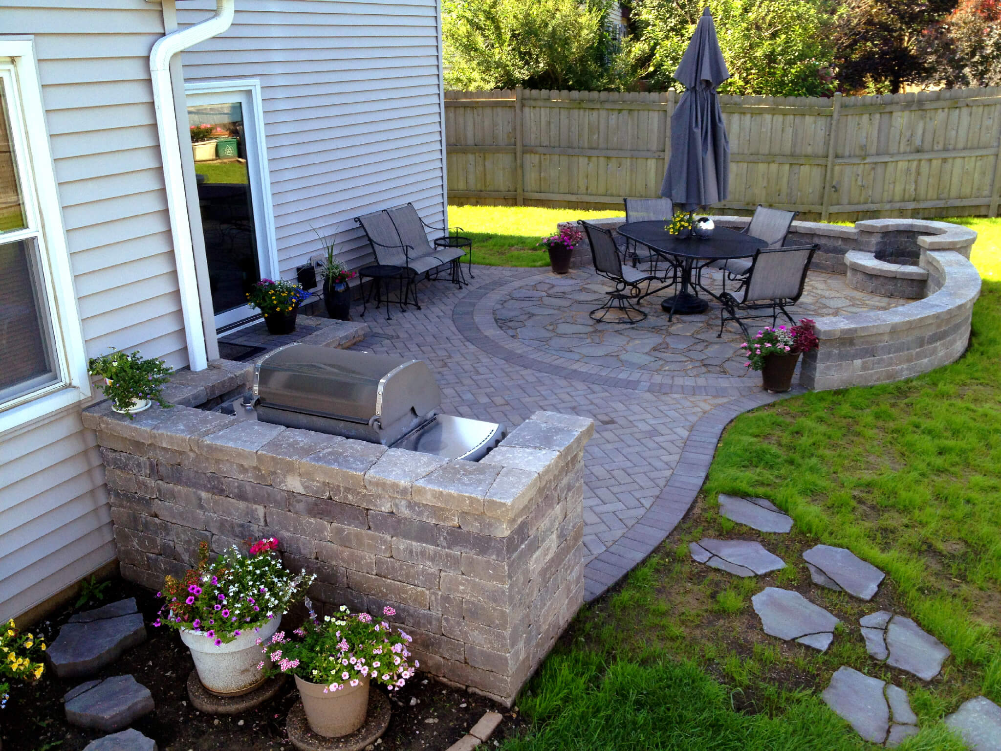 Patio with outdoor kitchen and fire pit