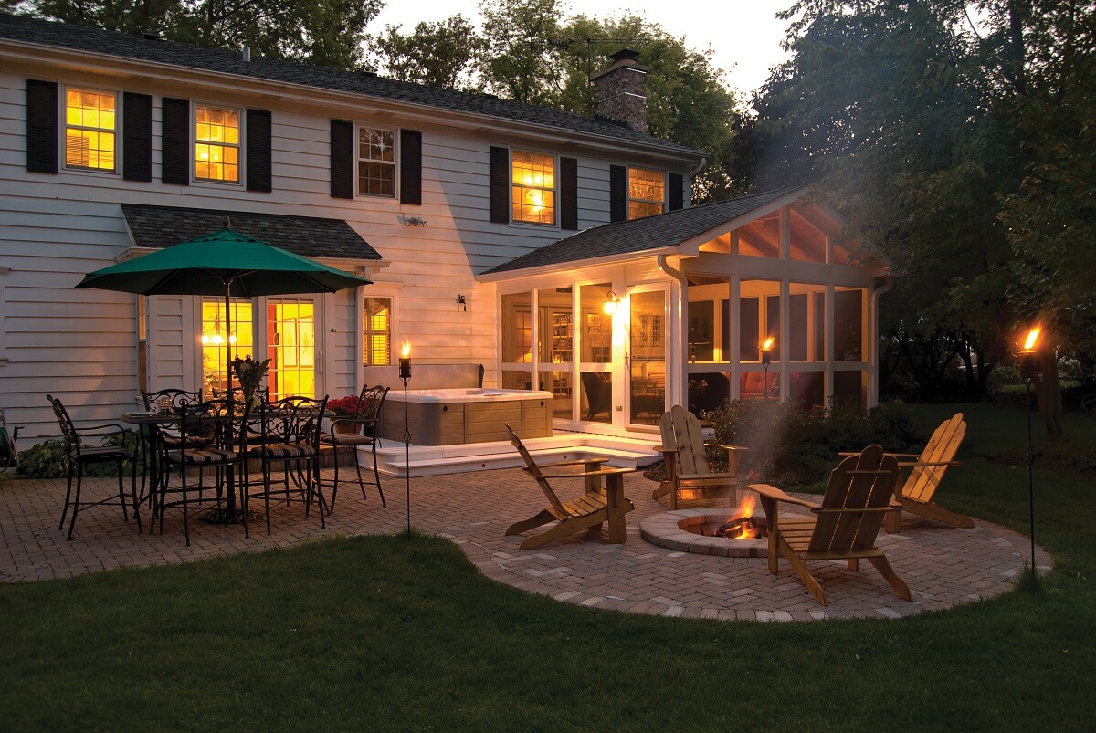 Screened porch and hot tub on patio with fire pit