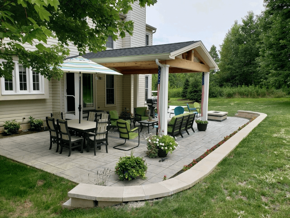 Cozy backyard covered patio with dining area and fire pit