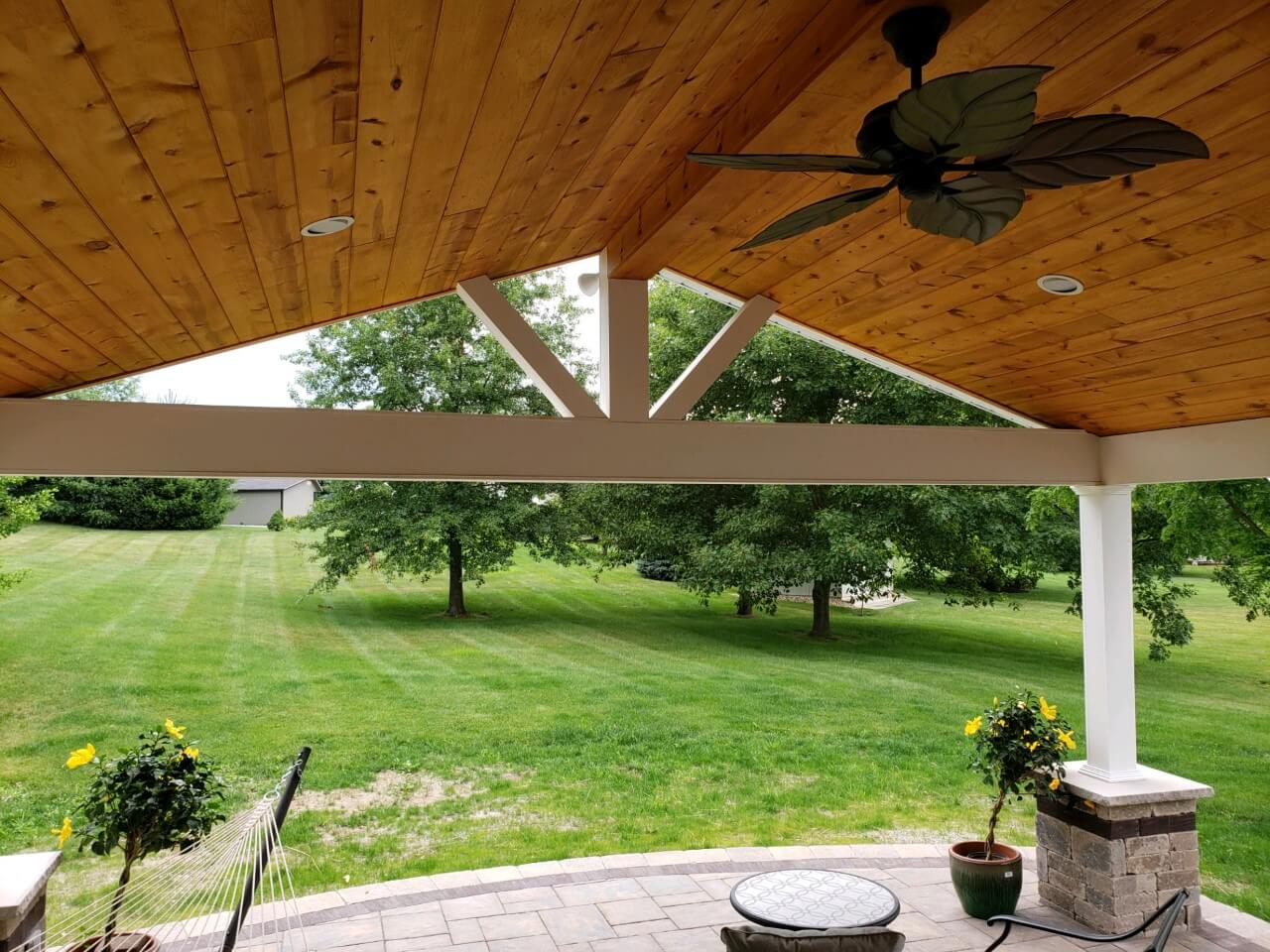 Backyard view from covered patio with wood ceiling