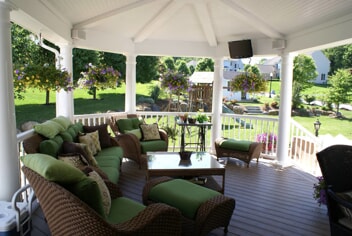 Open porch with octagonal roof featuring an open rafter and beadboard interior ceiling.