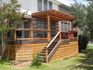 custom deck with pergola and staircases with privacy railings