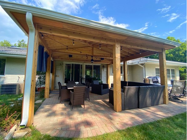 Escape the elements and enjoy your outdoor space year-round with a custom-built covered porch! This Lake Forest addition is perfect for entertaining.