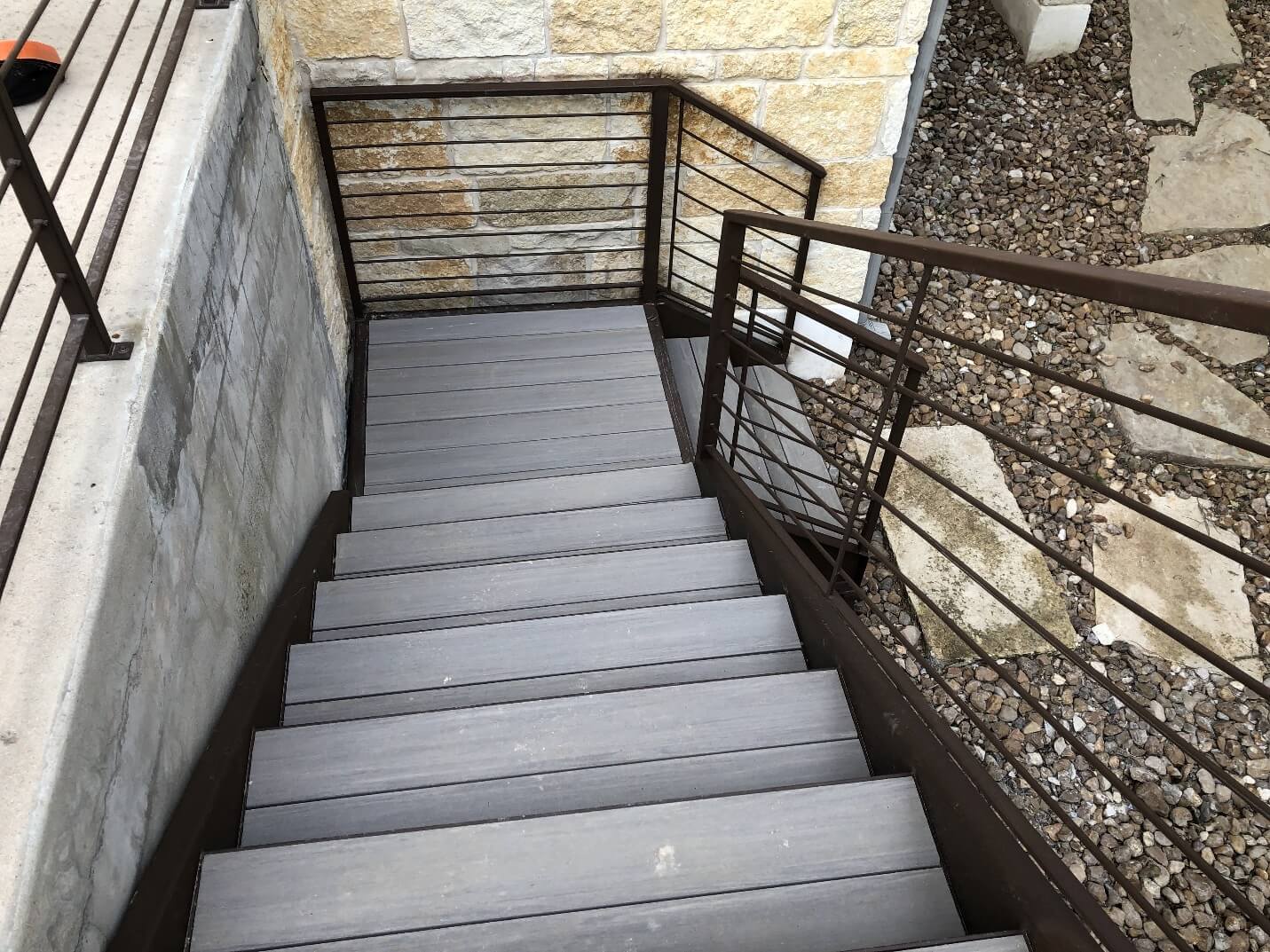 Gray pool deck stairs with railing