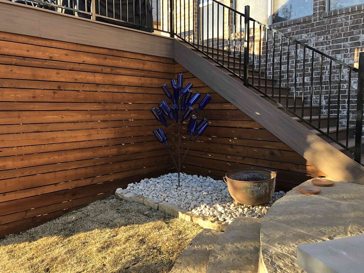 Deck stairs with railing and bottle tree decor