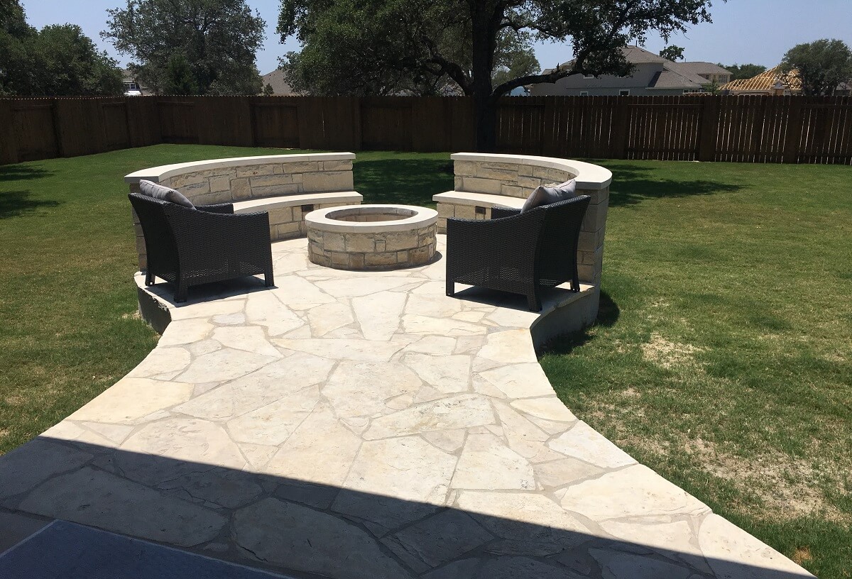 Custom patio with fire pit and seat wall