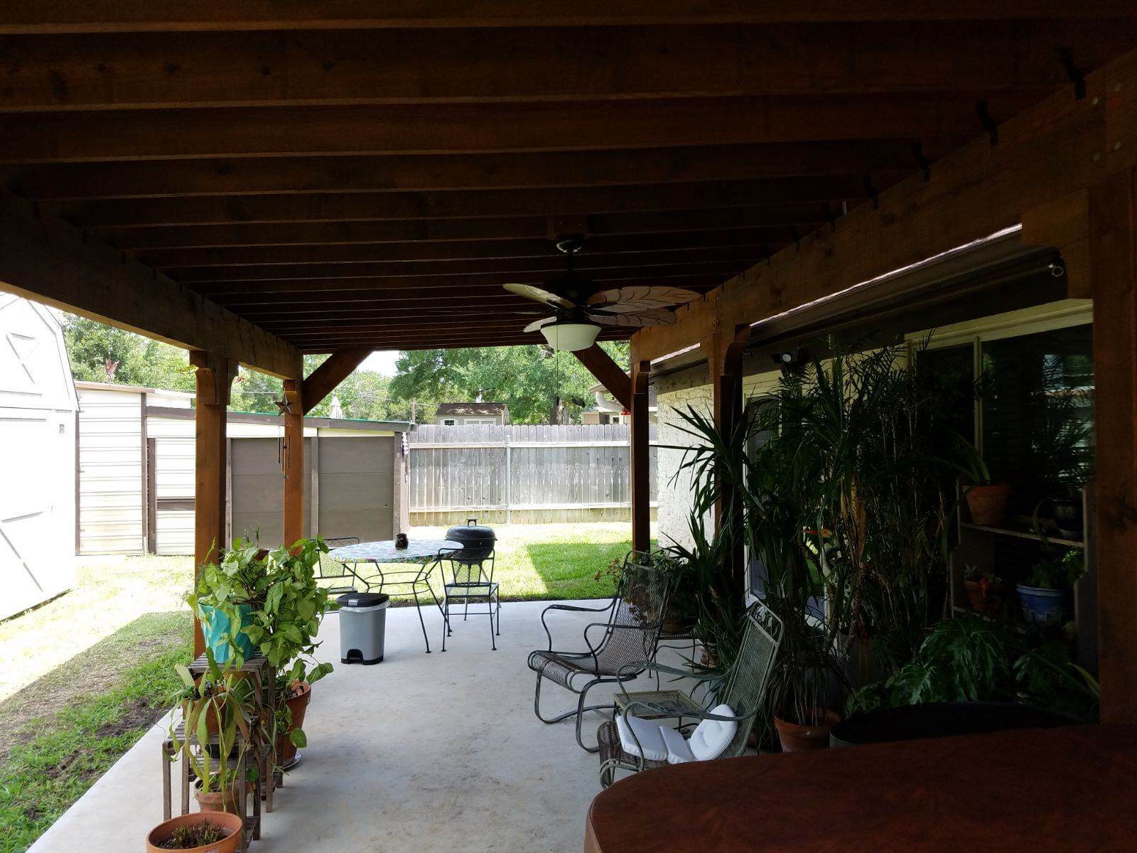 Pergola with ceiling fan over backyard patio