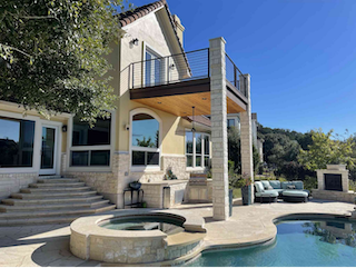 exterior of the back of a home with a pool