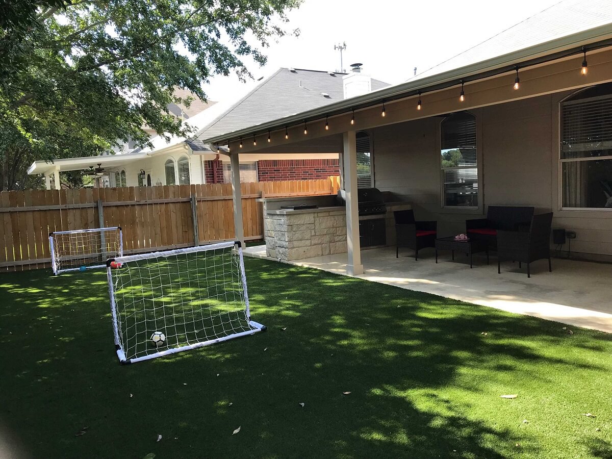 Backyard covered patio and kiddie football area