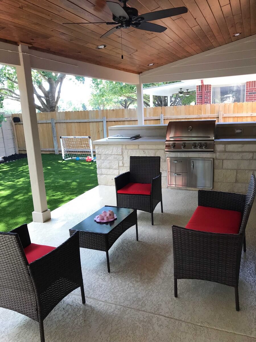 Covered patio with outdoor kitchen and seating area