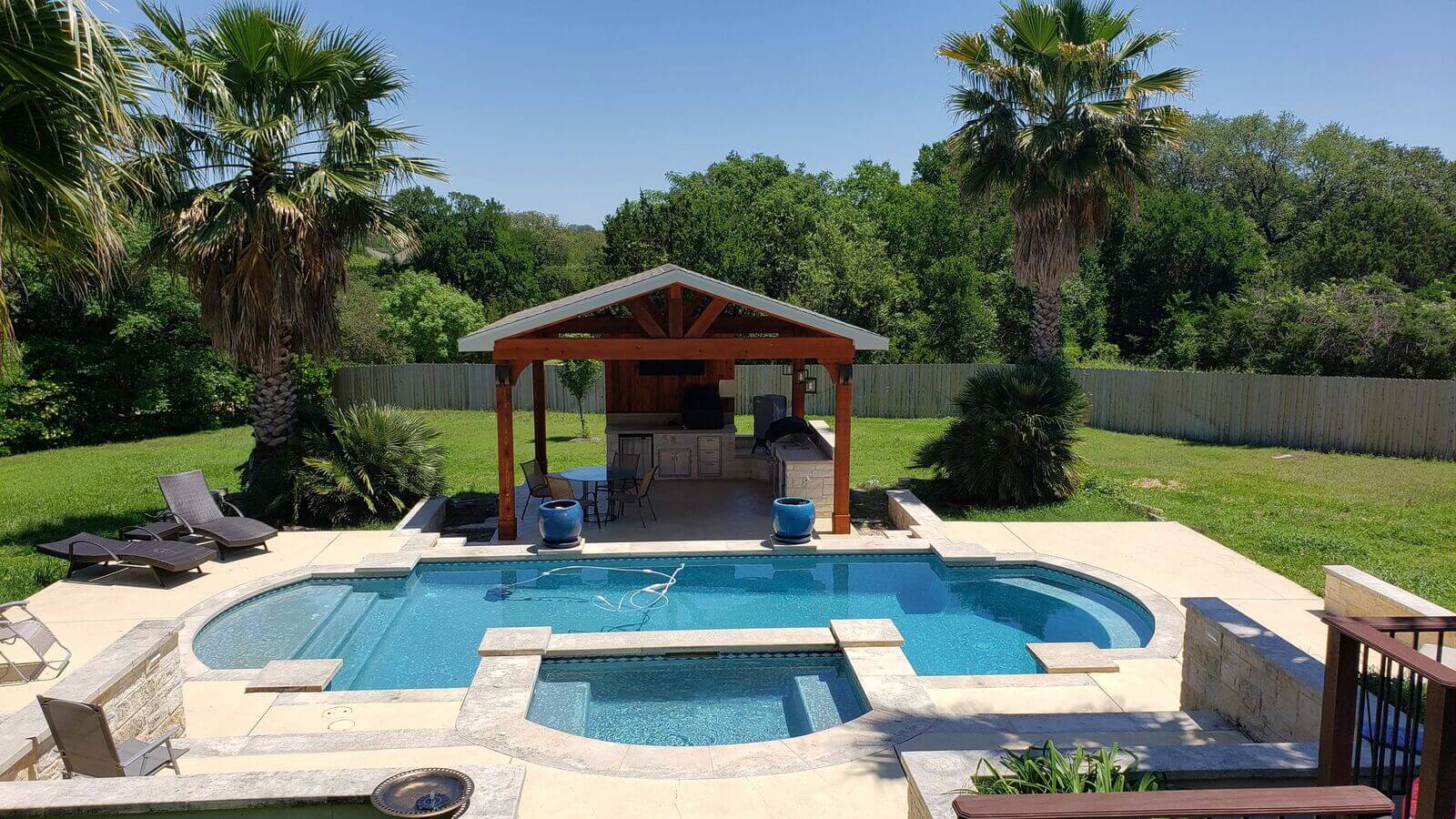 View of new backyard with pool and cabana with outdoor kitchen