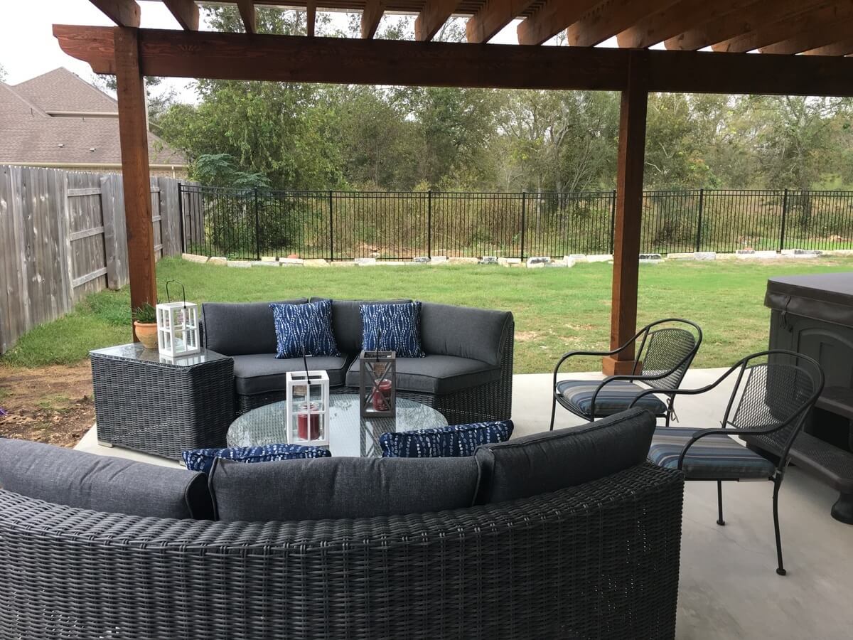 Cozy seating area on patio with pergola cover