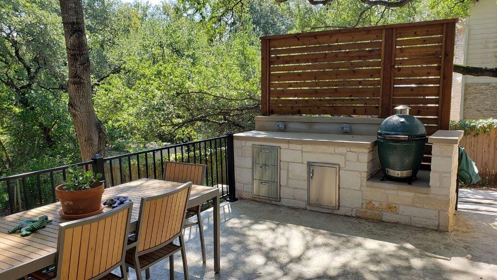 Outdoor kitchen with dining area on deck