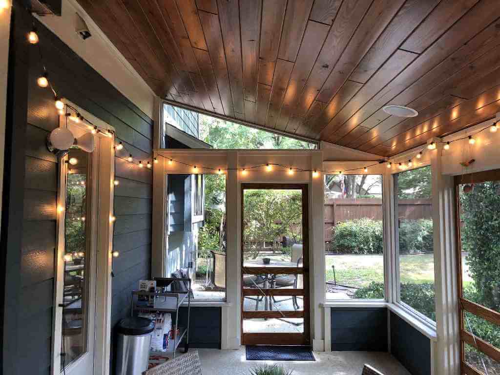 Interior view of screened porch with hanging lights