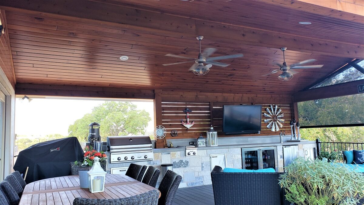 Custom outdoor kitchen and dining area on deck