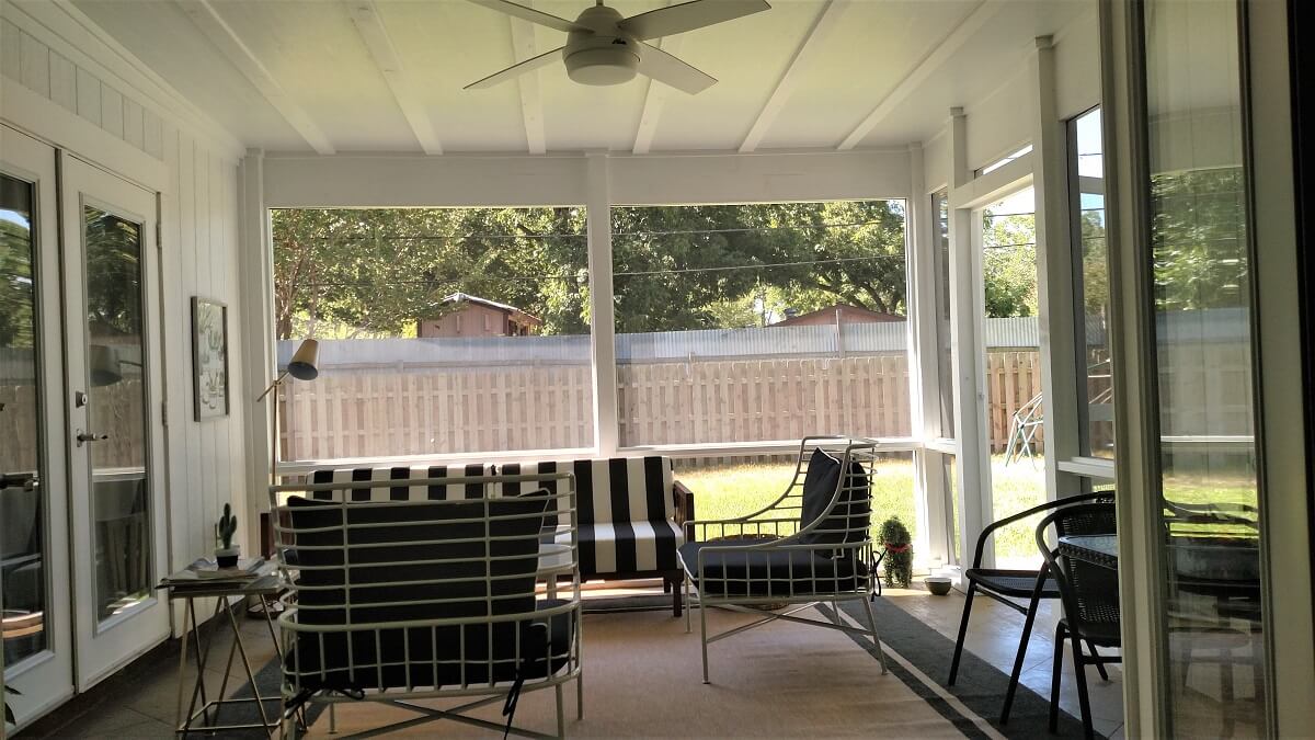 Inside view of screened porch with seating area