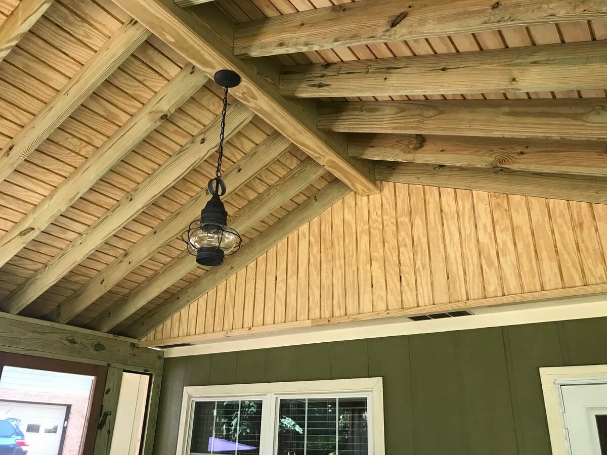 Screened porch ceiling details with hanging lighting