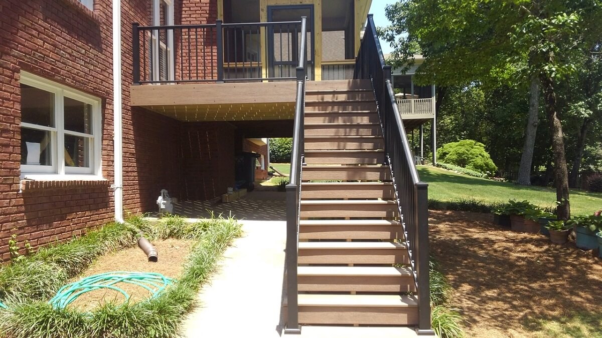 Front view of wood deck with railing and staircase