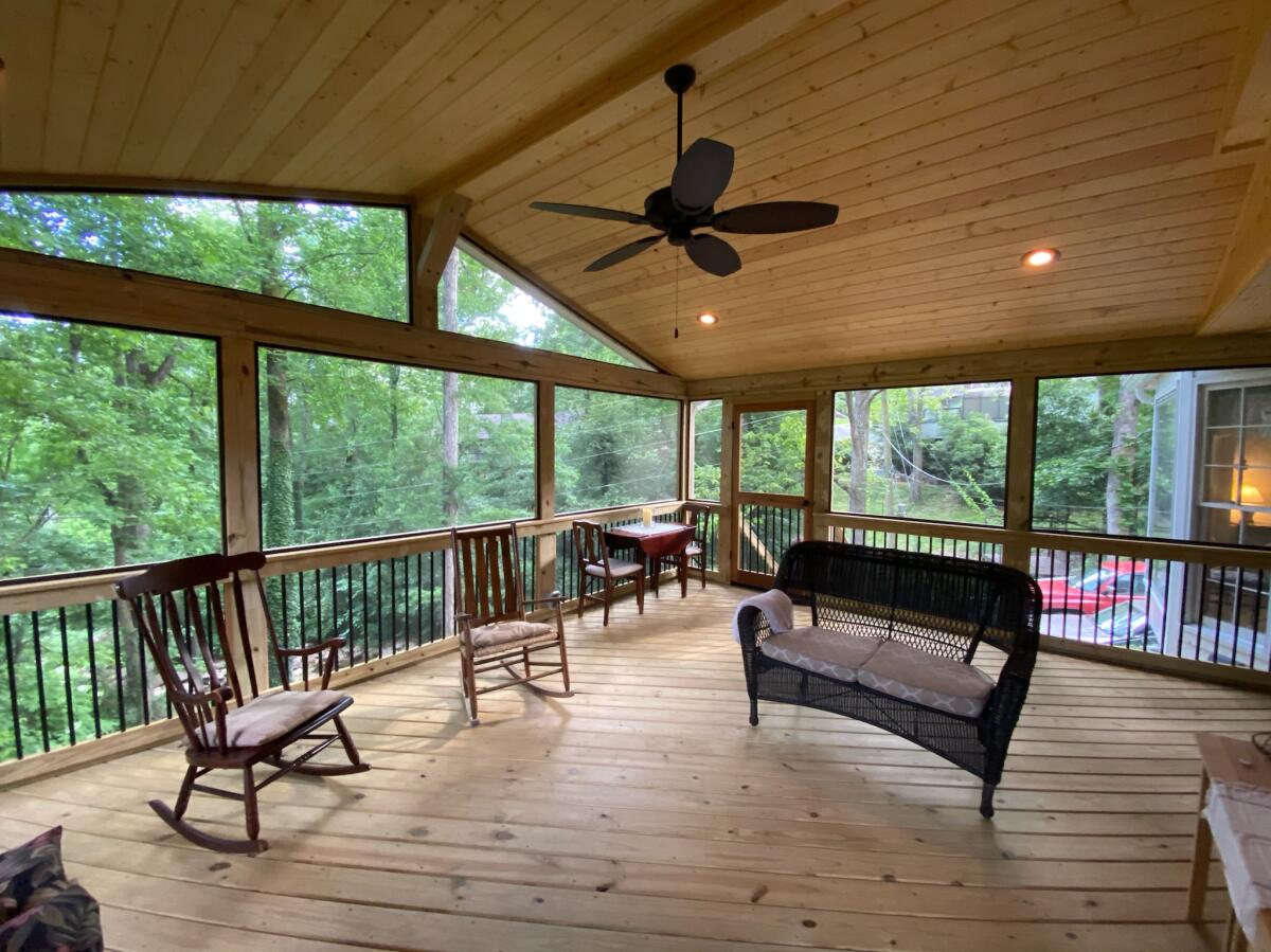 A porch with a fan and chairs
AI-generated content may be incorrect.