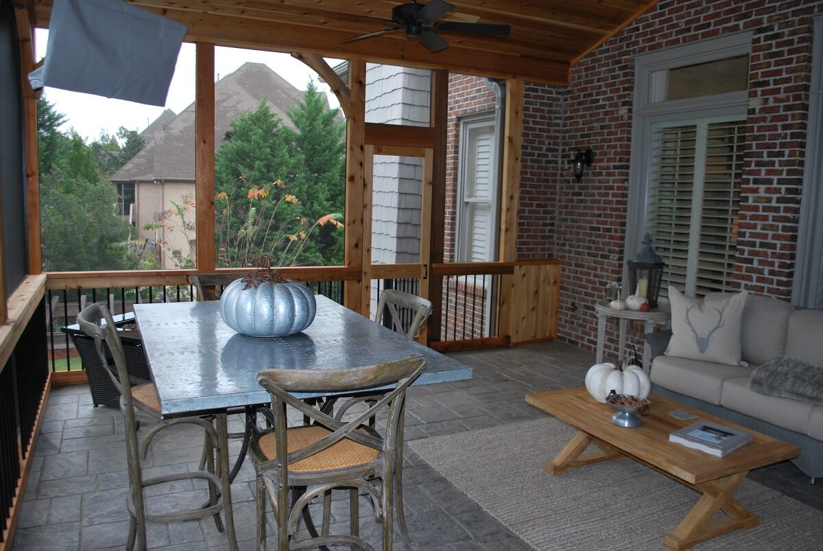 Custom screened porch with dining area, ceiling fan and mounted flat TV