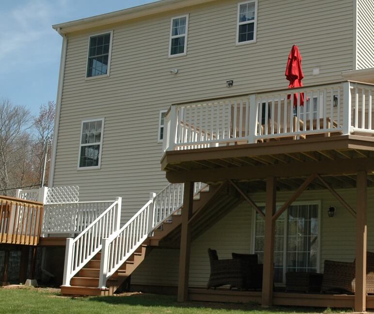 Custom backyard multi-level deck with railing and staircase