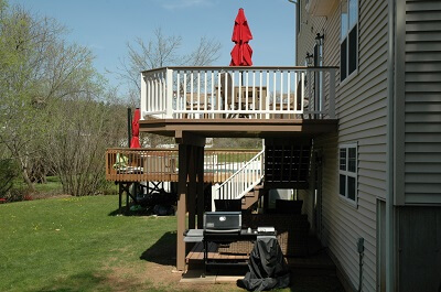Custom backyard multi-level deck with railing and staircase