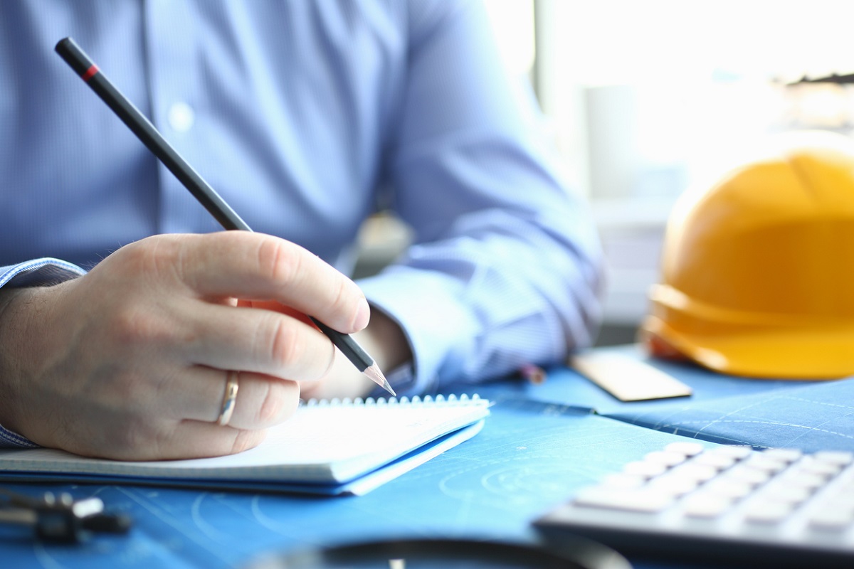 Well Dressed Adult Holding Pencil to Paper