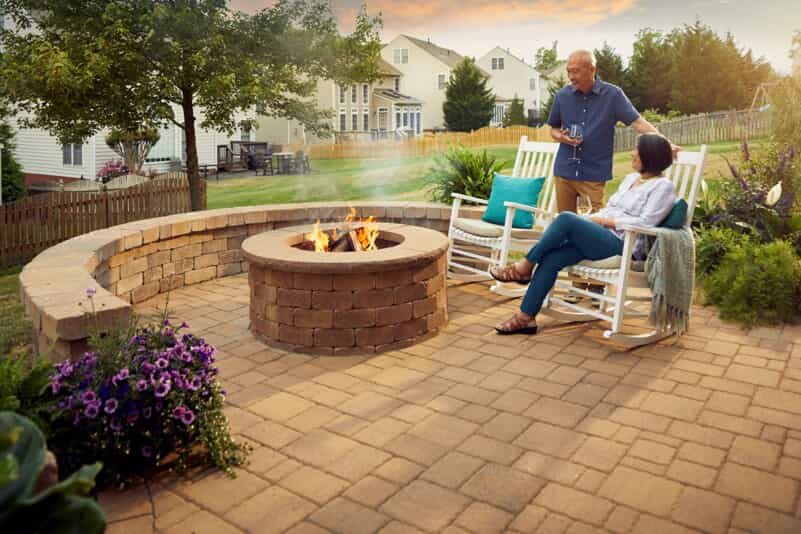 couple with patio and fire pit