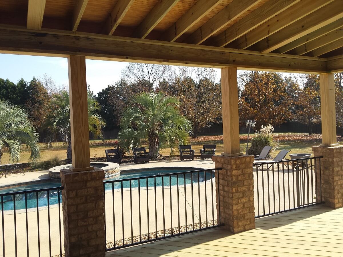 Covered porch and deck overlooking pool