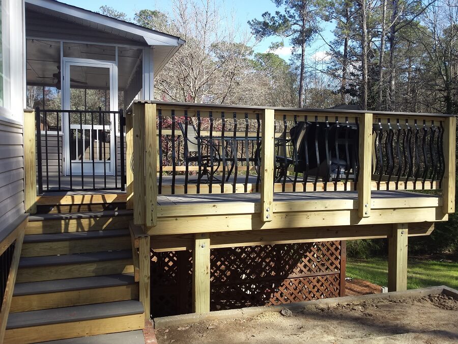 Side view of custom deck with iron railing and staircase