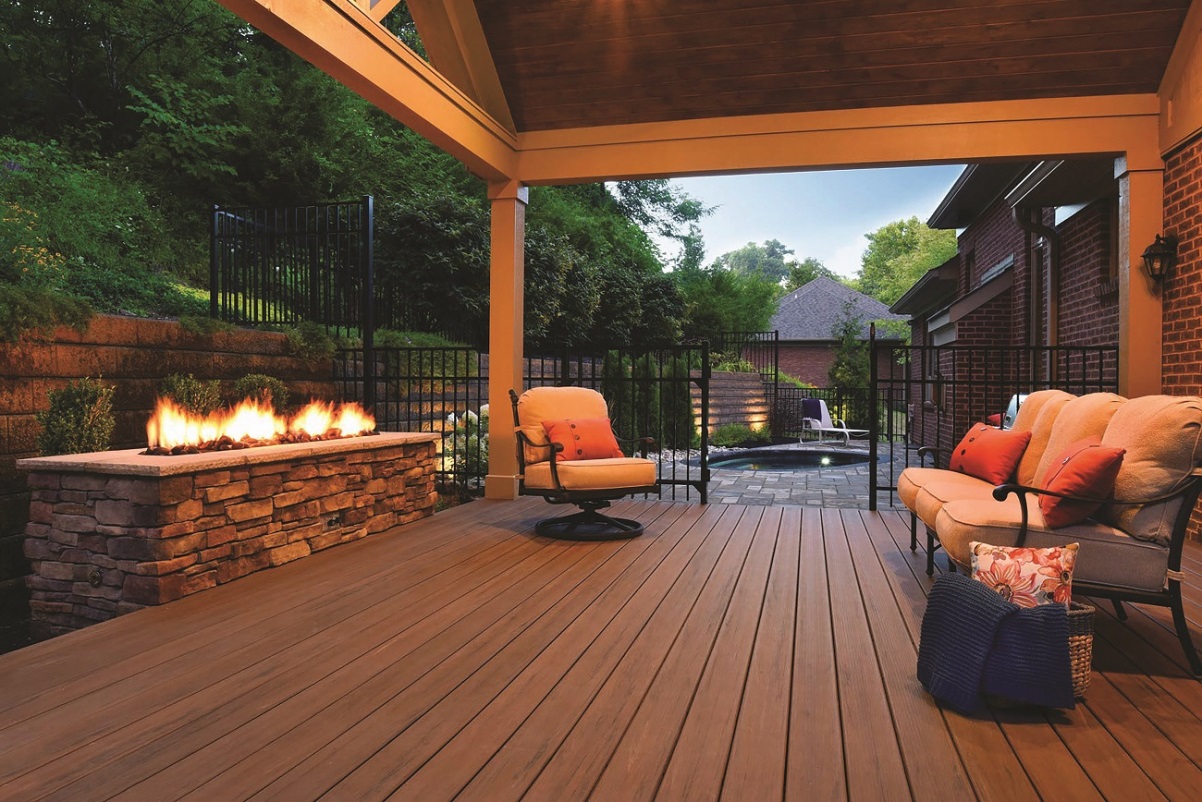 covered patio with outdoor furniture and fireplace