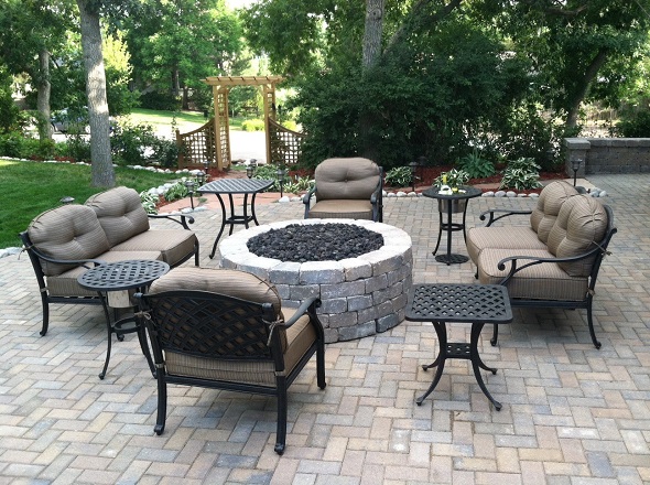outdoor hardscape patio with chairs and fireplace