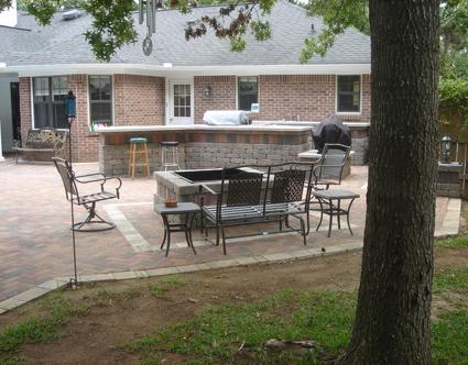 Patio with outdoor kitchen area and seating area with firepit