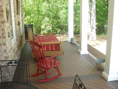 rocking chair and swing chair on front porch deck 