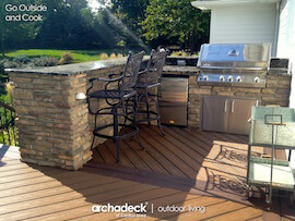 Custom outdoor kitchen with bar counter on deck