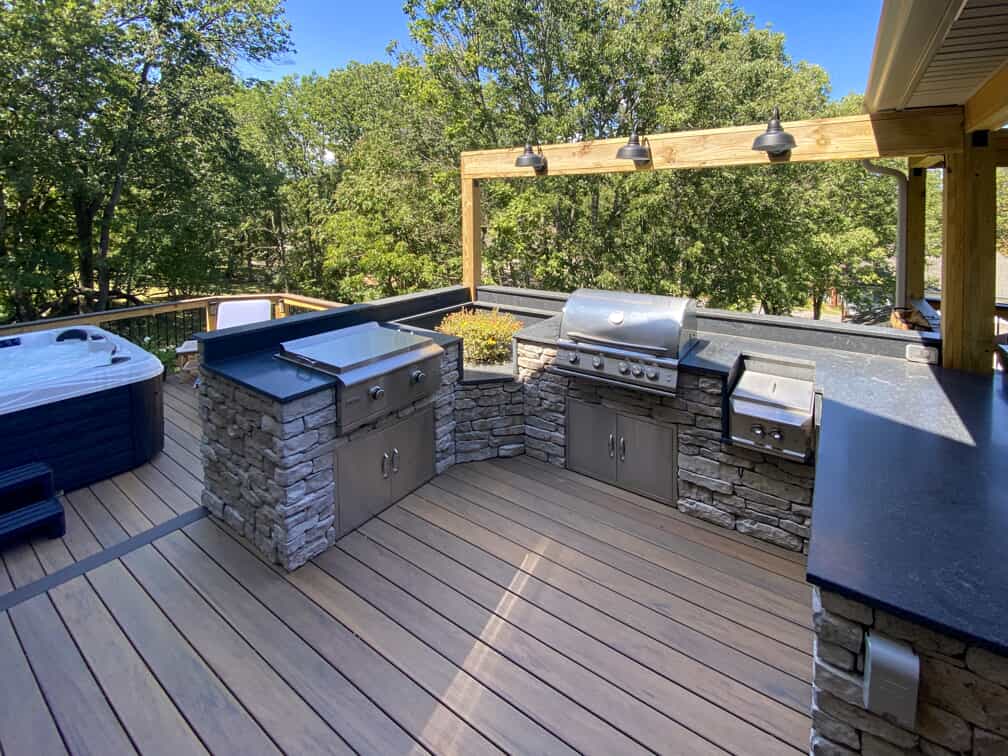 Outdoor kitchen with stone counters on deck