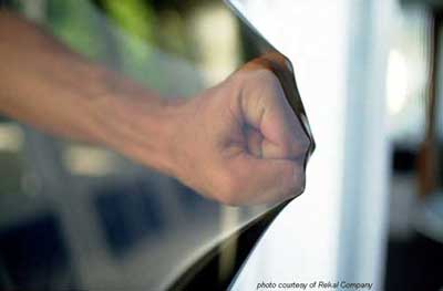 fist stretching a screen window