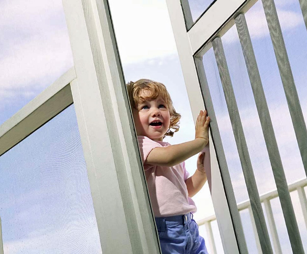 child opening a screen door