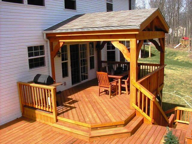 Custom backyard multi-level deck with seating area and outdoor grill