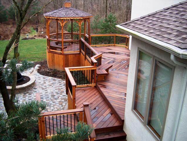 Custom backyard multi-level deck and porch with floating bench and gazebo