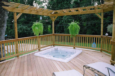 Custom pool deck with pergola and hanging plants