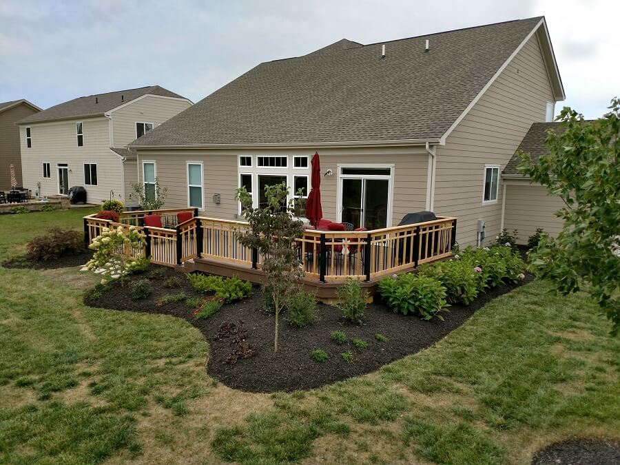 Custom deck and patio with seating area and outdoor kitchen