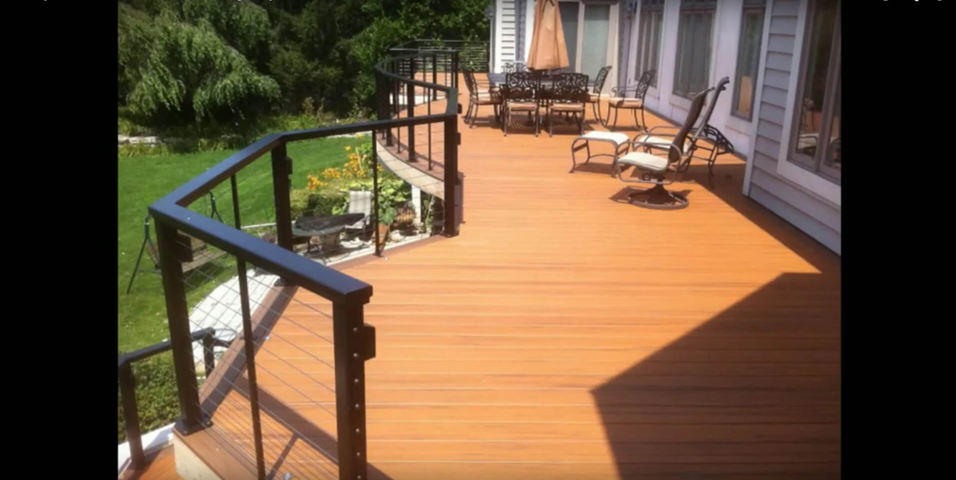 Custom backyard deck with seating area and railing