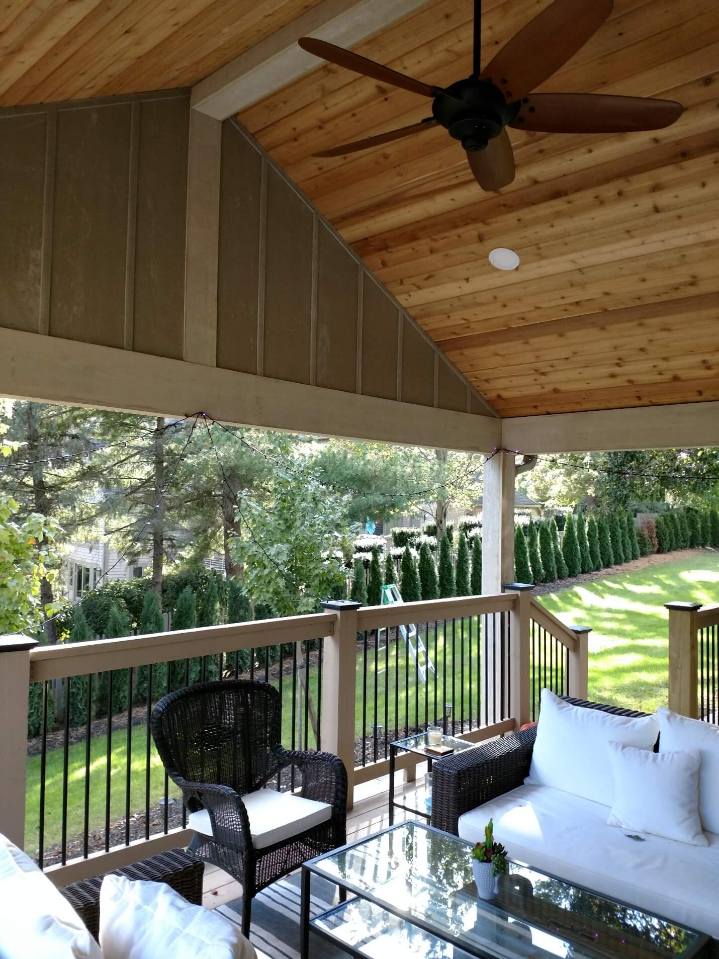 Covered porch seating area and backyard view