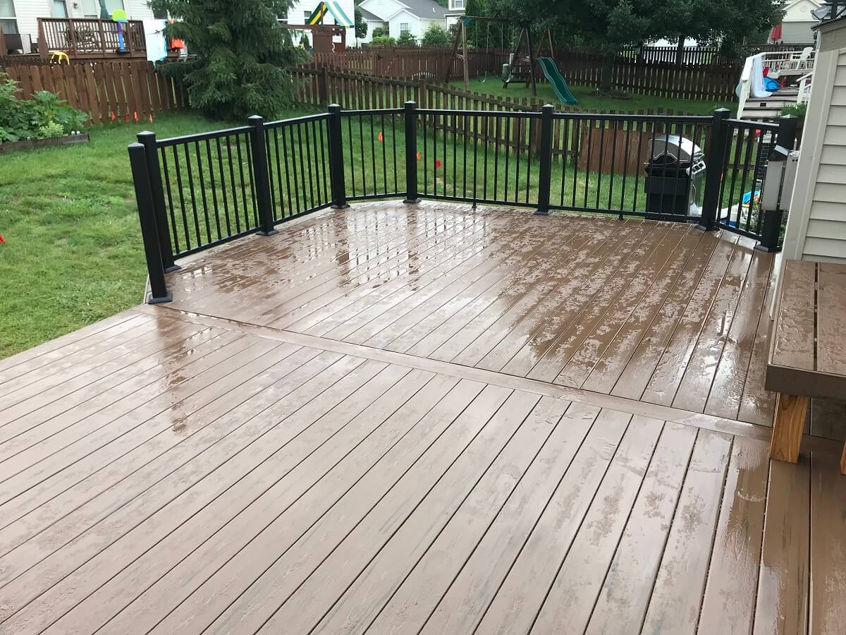 Custom backyard wood deck with railing