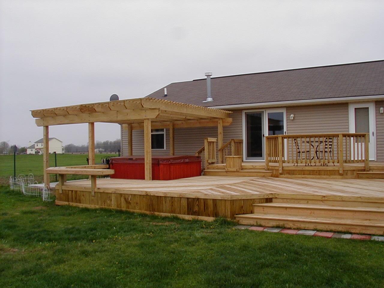 Custom hot tub deck with pergola and floating benches