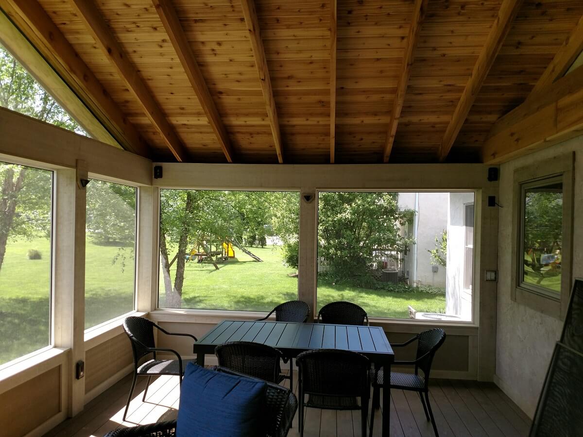 Screened porch with dining area and backyard view