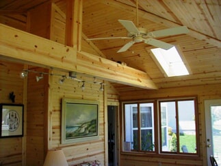 rustic screen porch with ceiling fan 