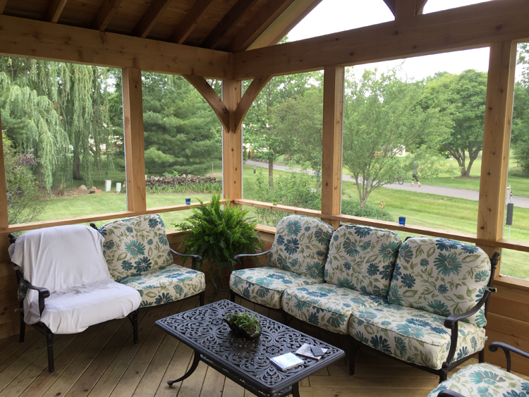 Cedar screened porch with drink rail.