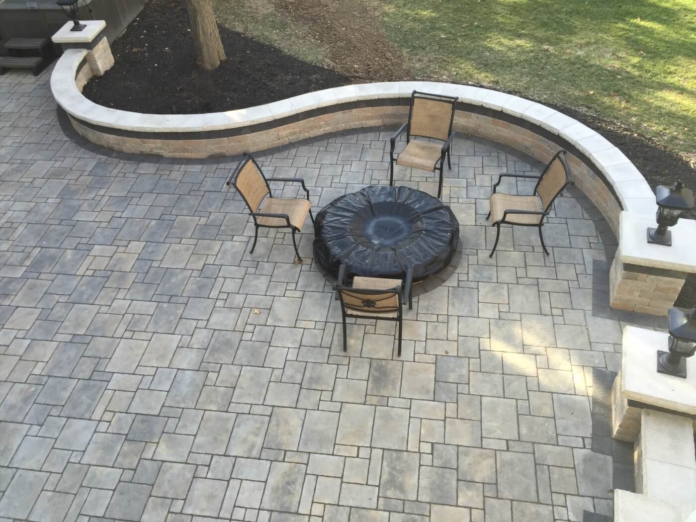 Aerial view of patio with outdoor furniture and seating wall